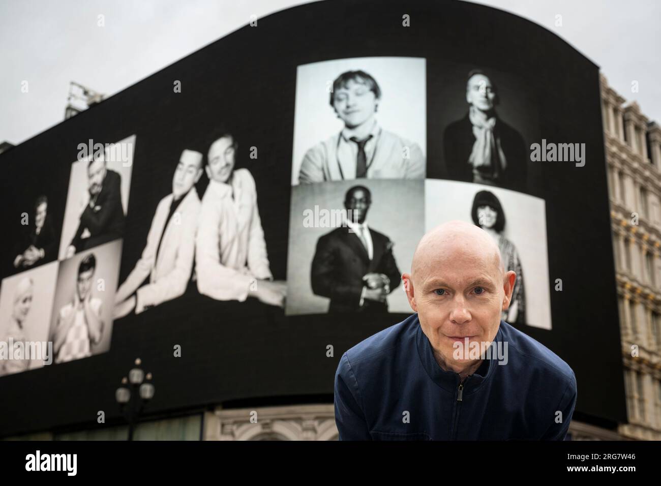 London, UK.  8 August 2023. Photographic artist Ray Burmiston at the launch of ‘Art of London Presents Take A Moment 2023’, his new photography exhibition featuring hundreds of famous faces with their eyes closed for mental health awareness.  Faces, including Tom Daley and Rupert Grint, are seen on the big screens at Piccadilly Circus, ahead of an exhibition in the National Portrait Gallery in September.  Credit: Stephen Chung / Alamy Live News Stock Photo