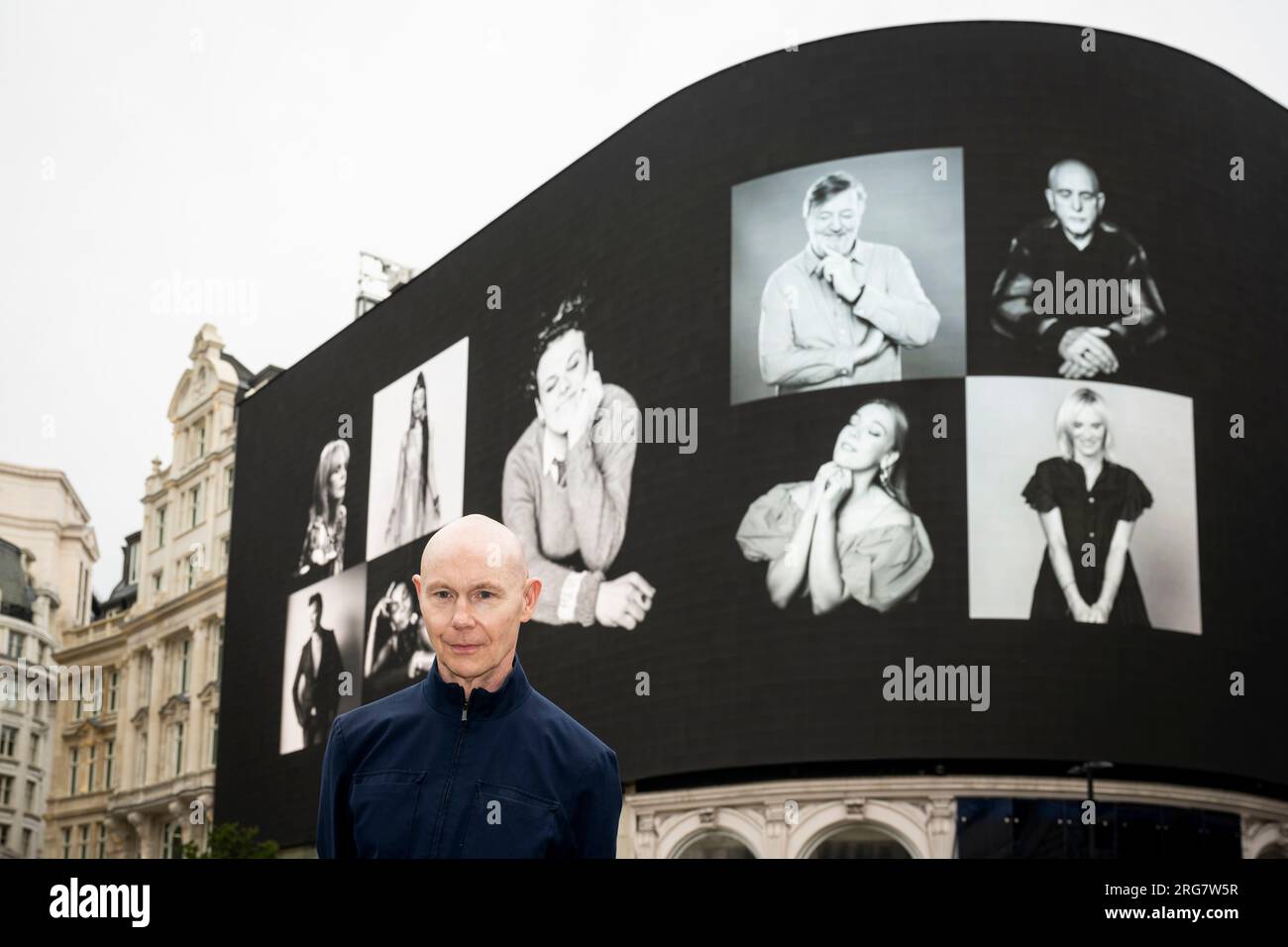 London, UK.  8 August 2023. Photographic artist Ray Burmiston at the launch of ‘Art of London Presents Take A Moment 2023’, his new photography exhibition featuring hundreds of famous faces with their eyes closed for mental health awareness.  Faces, including Stephen Fry, are seen on the big screens at Piccadilly Circus, ahead of an exhibition in the National Portrait Gallery in September.  Credit: Stephen Chung / Alamy Live News Stock Photo