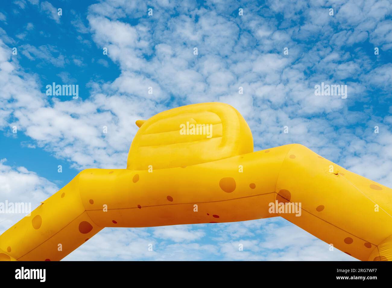 Yellow inflatable advertising banner with no lettering against the sky. Stock Photo
