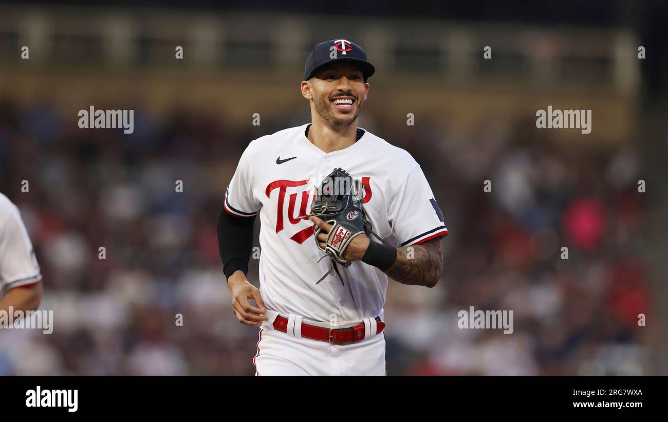 Minnesota Twins' Carlos Correa smiles while heading to the dugout at ...