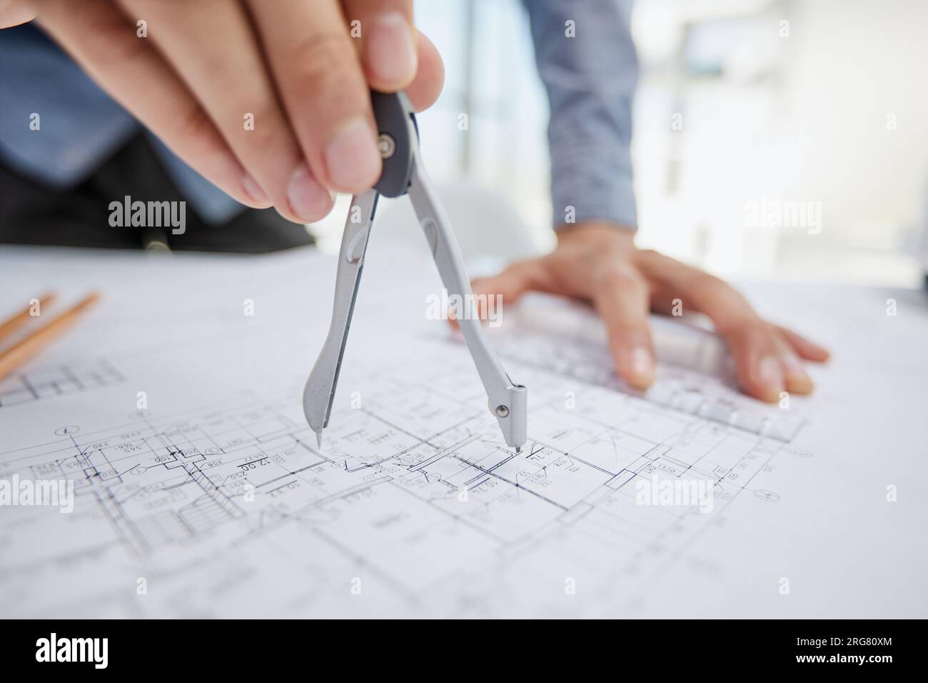 Architect working on drawing table in office Stock Photo