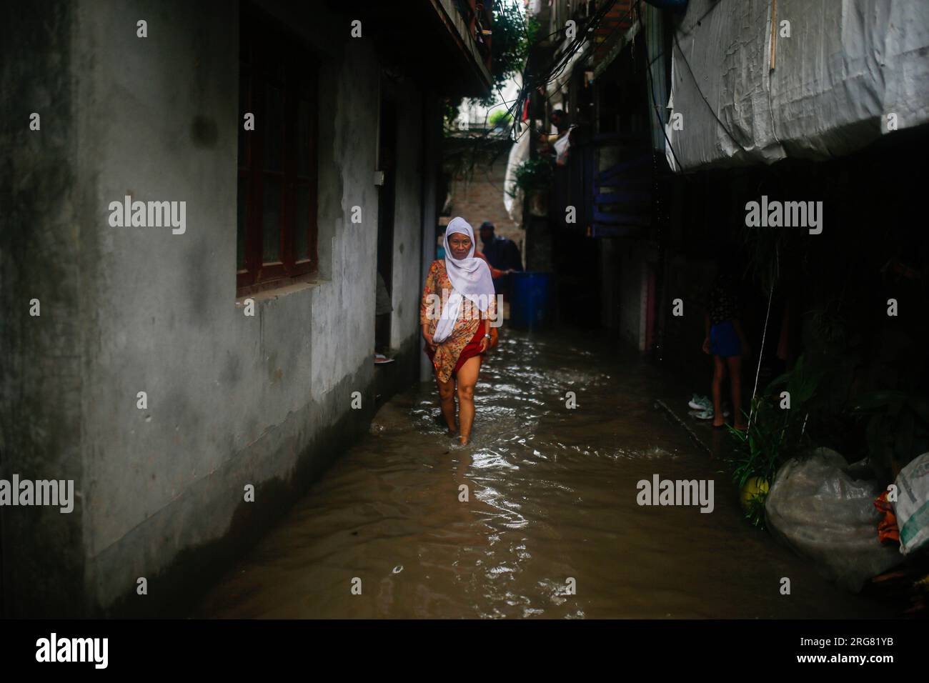 Kathmandu, Nepal. 08th Aug, 2023. A Woman Wades Through Flooded Homes ...