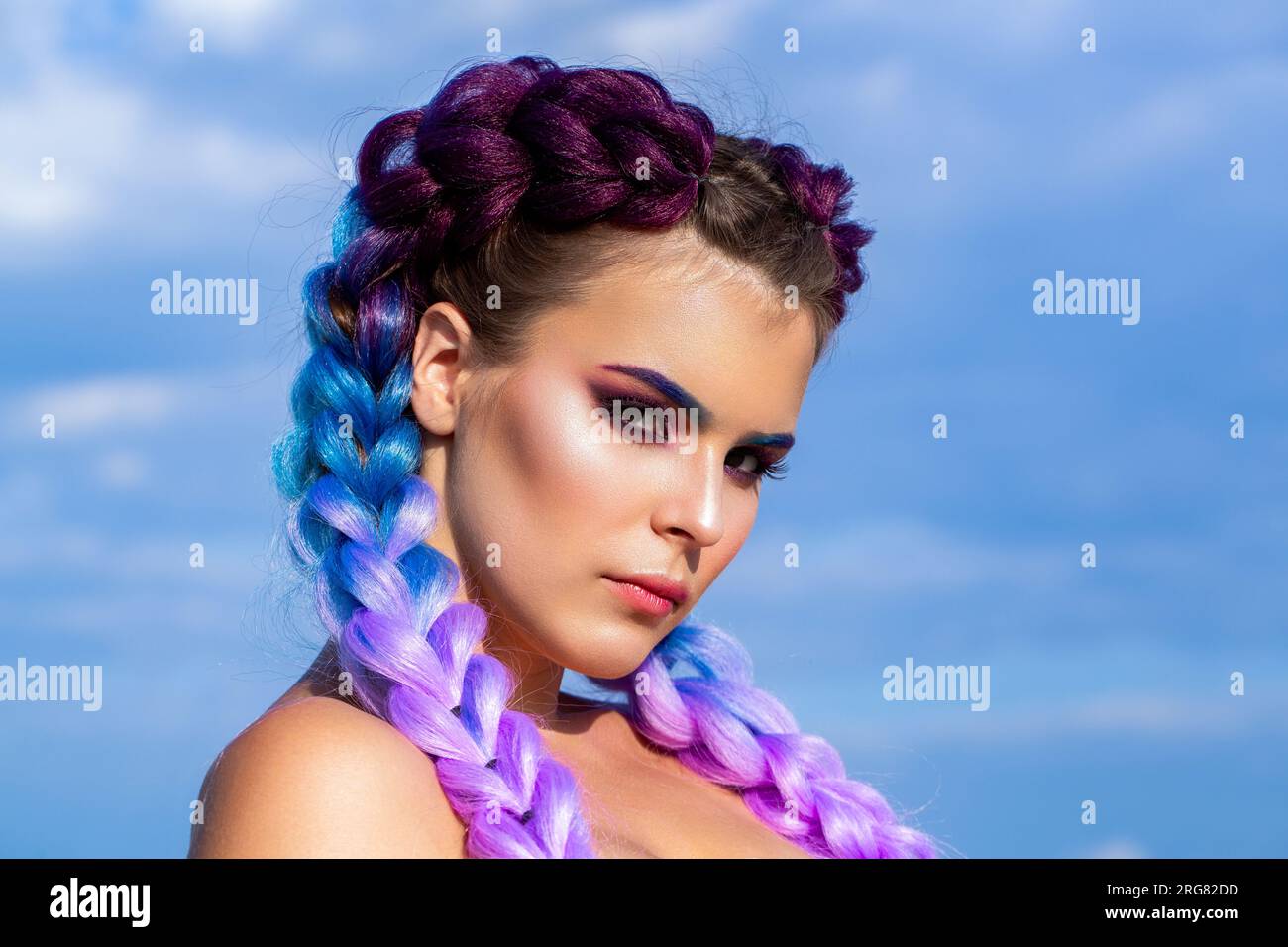 Girl colorful kanekalon braided in her hair. Pretty woman colorful violet  ombre hair and pro makeup. Girl braids on background sky. Bright makeup  Stock Photo - Alamy