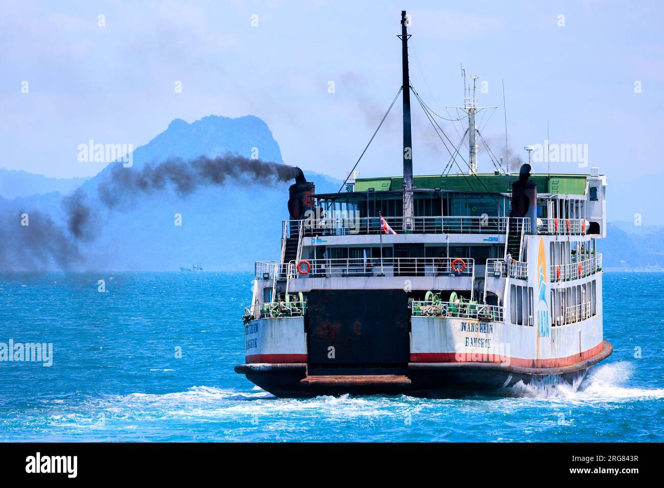 Ferry boat exhausting dark polluted smoke, Thailand Stock Photo