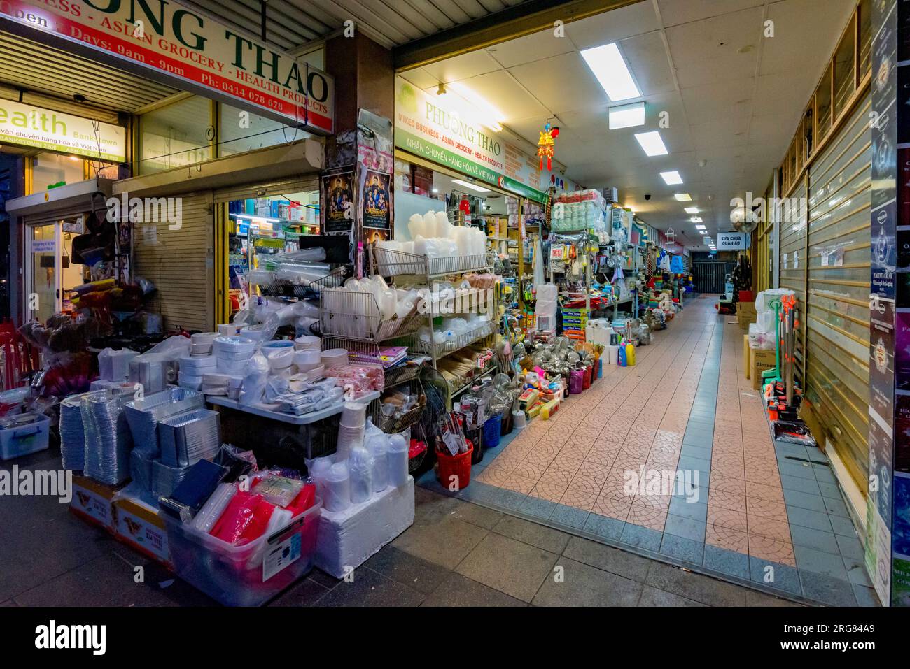 A small independent grocer or supermarket store in Bankstown, Sydney, Australia with goods for sale stacked up on the street and outside the store Stock Photo