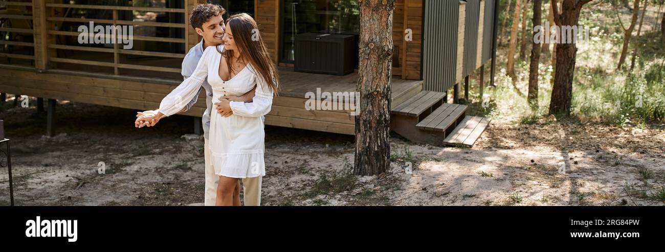 banner, man hugging woman near vacation house, in forest, summer and ...