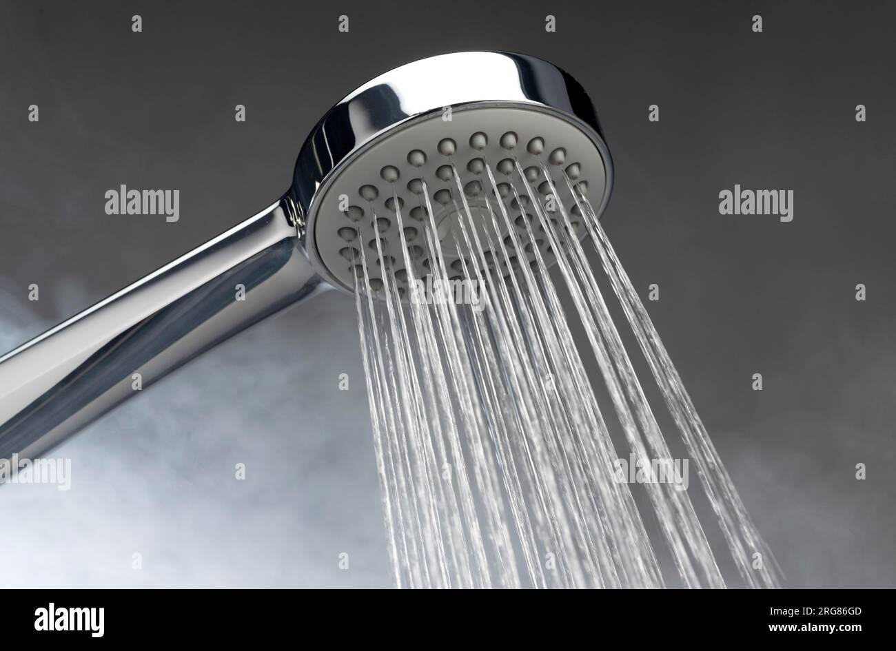 Chrome silver shower head with running water on a bathroom. Water Running from the shower. #shower Stock Photo