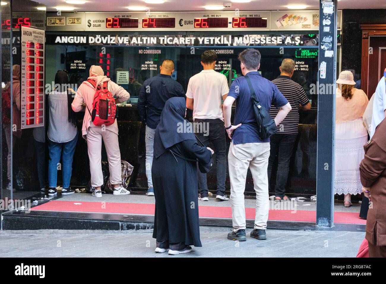 Istanbul, Turkey, Türkiye. Patrons at a Currency Exchange Kiosk. Stock Photo