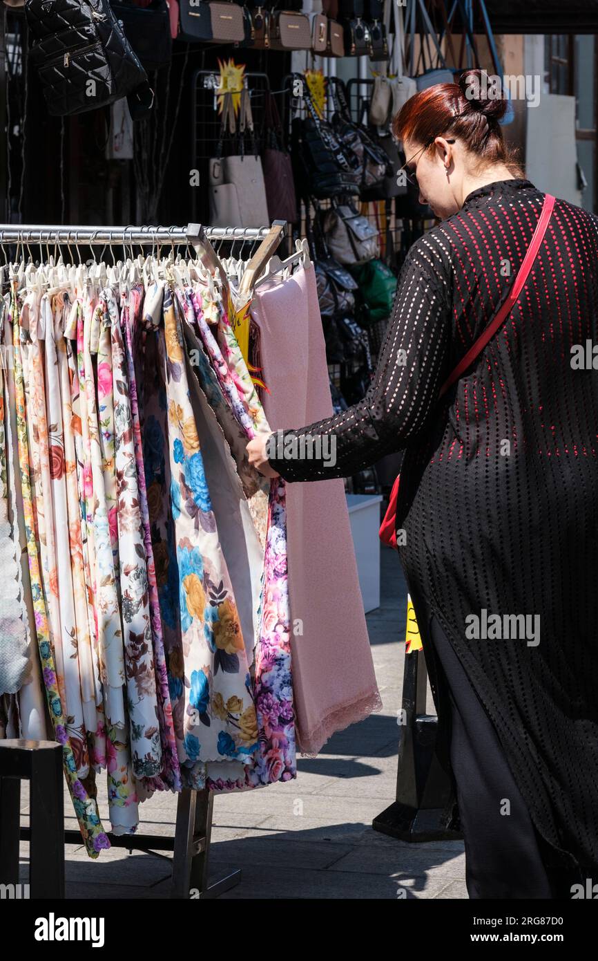Istanbul, Turkey, Türkiye. Turkish Woman in Black Examining Floral ...