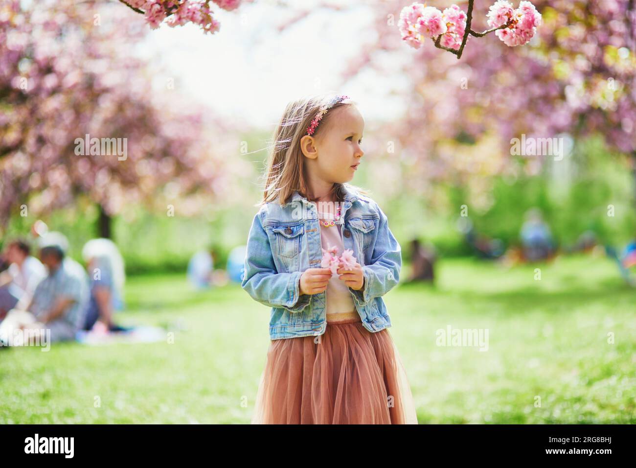Adorable preschooler girl in tutu skirt enjoying nice spring day in ...