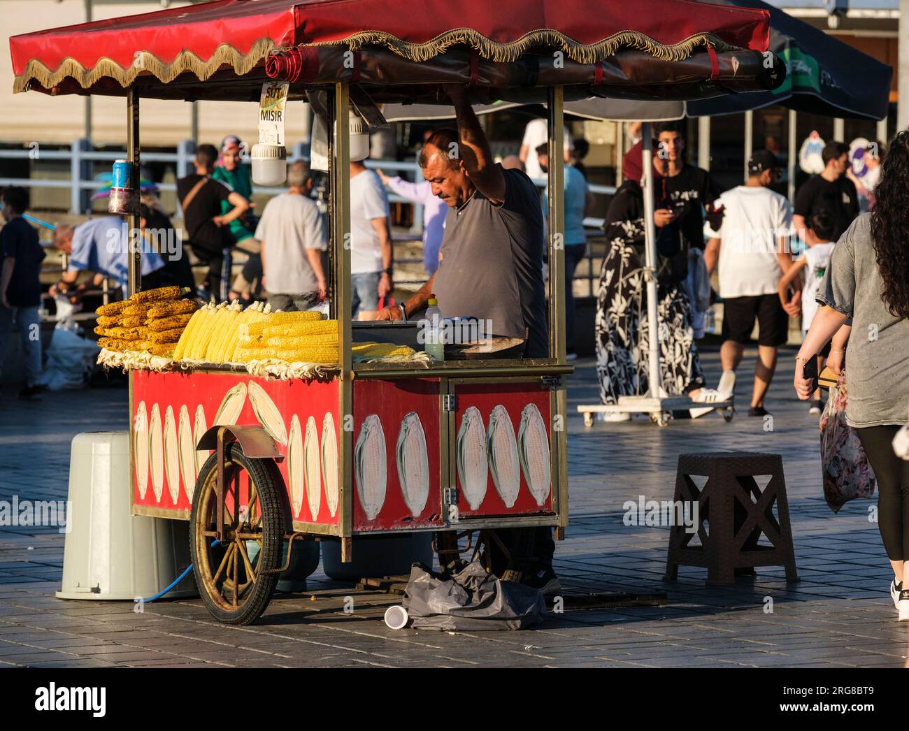 Istanbul, Turkey, Turkiye. Vendor of Roasted Corn on the Cob, by the Galata Bridge. Stock Photo