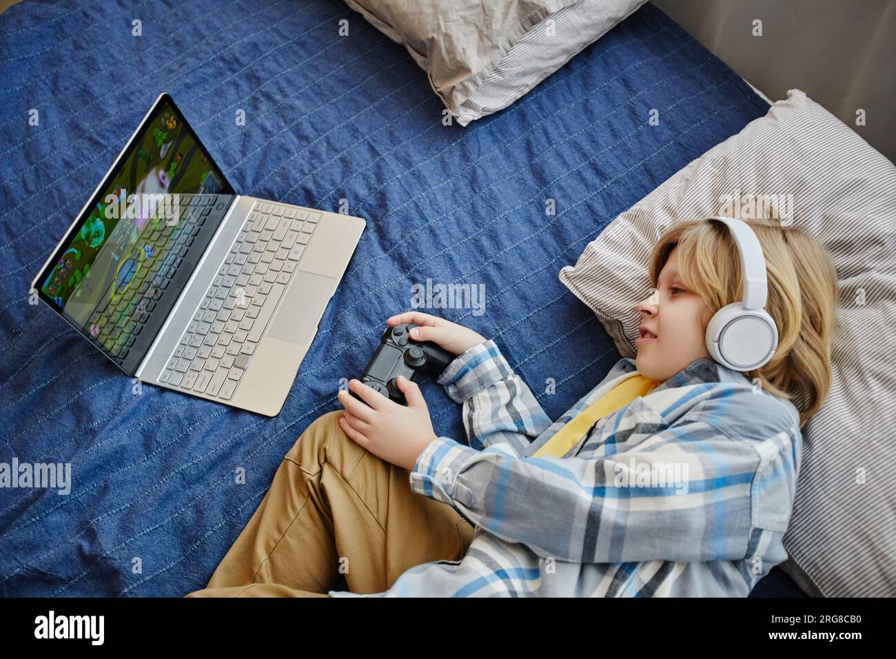 Boy headphones on head laptop hi-res stock photography and images - Alamy