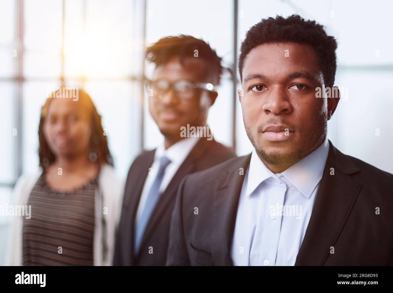 group of young business people standing in the office lobby Stock Photo ...