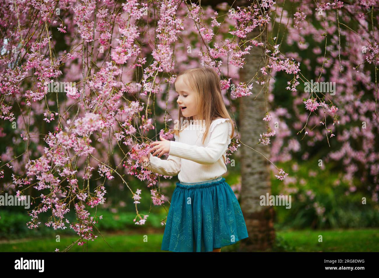 Springtime Kids Outside Adorable preschooler girl enjoying nice spring day in park during ...