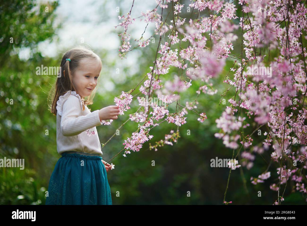 Springtime Kids Outside Adorable preschooler girl enjoying nice spring day in park during ...