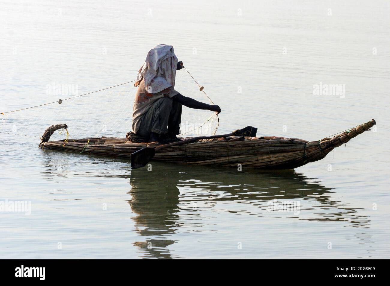 Man fishing on a boat made of local Papyrus and reeds in Lake Tana Ethiopia Stock Photo