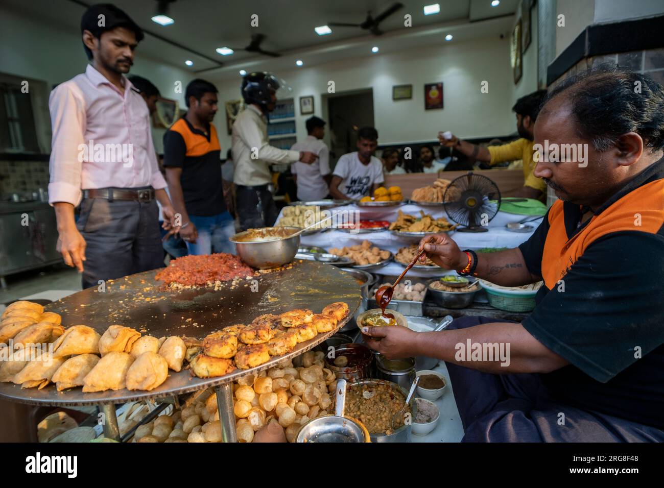 Varanasi India - March 13 2023 Food corner selling and preparing chaat in Varanasi, India Stock Photo