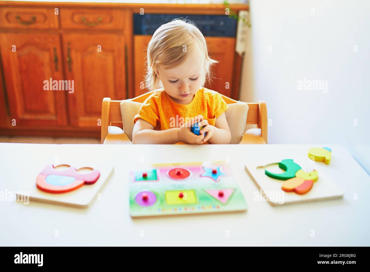 Little pre-school girl learns to solve puzzles online and plays educational  games on tablet at home - a Royalty Free Stock Photo from Photocase