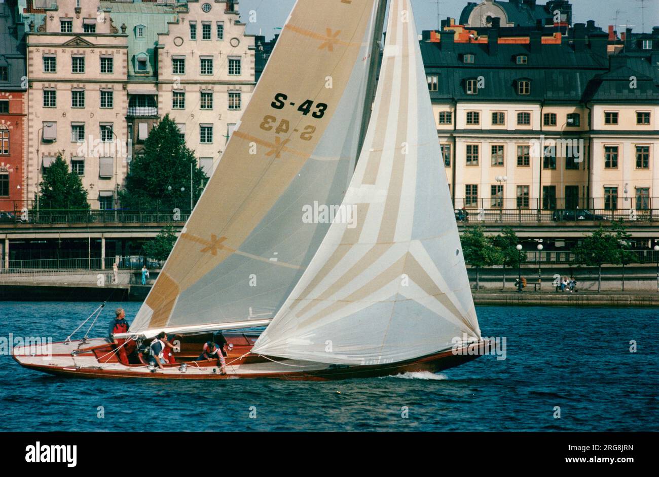 Sailing with a 43-foot boat in central Stockholm with the Old Town in the back-ground Stock Photo