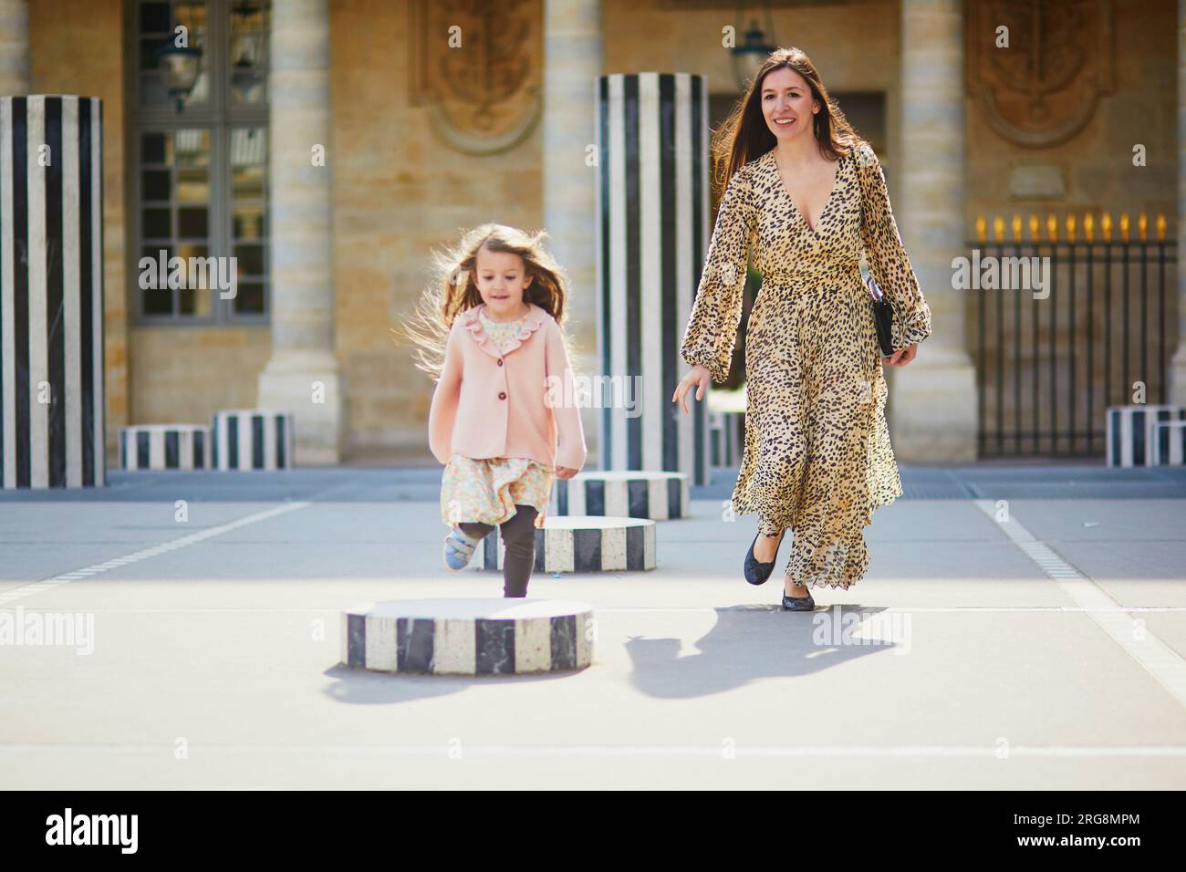 Happy family of two on a street of Paris. Mother with her adorable 4 ...