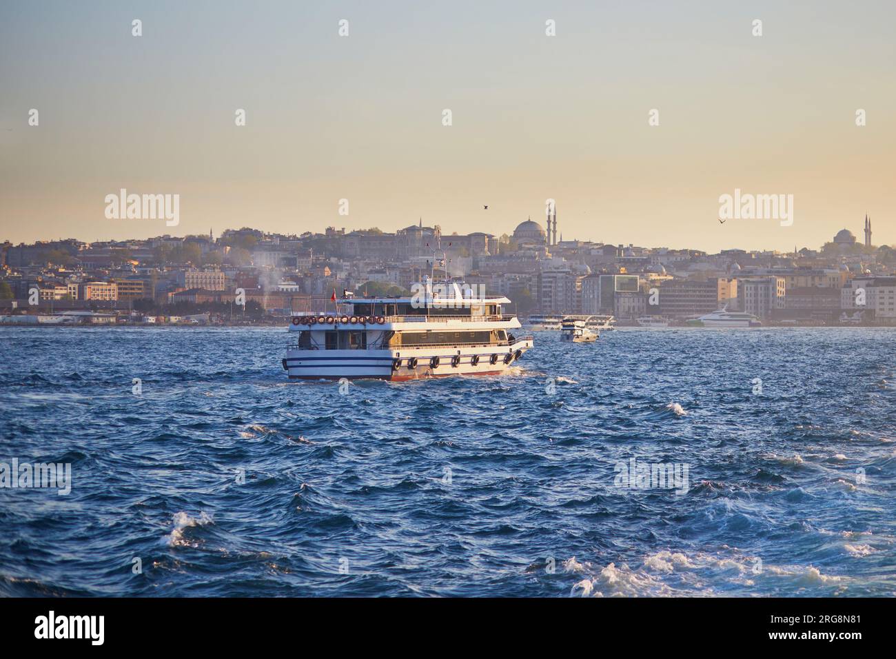 Passenger ferry sails across the Bosphorus strait in Istanbul, Turkey ...