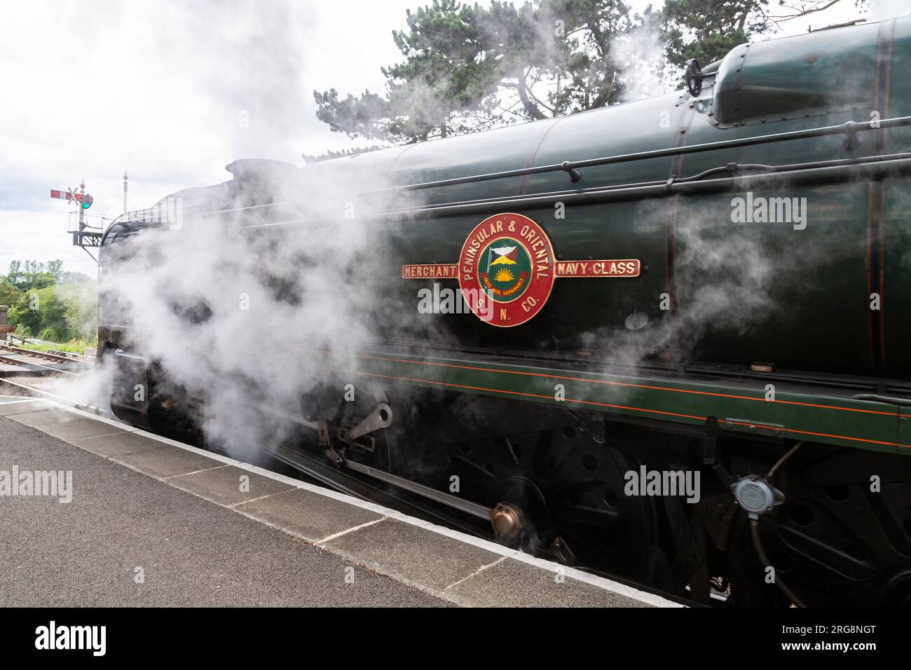 Merchant Navy Class 35002 'Peninsula and Oriental' steam locomotive preserved by the Gloucestershire and Warwickshire Steam Railway, letting off steam Stock Photo