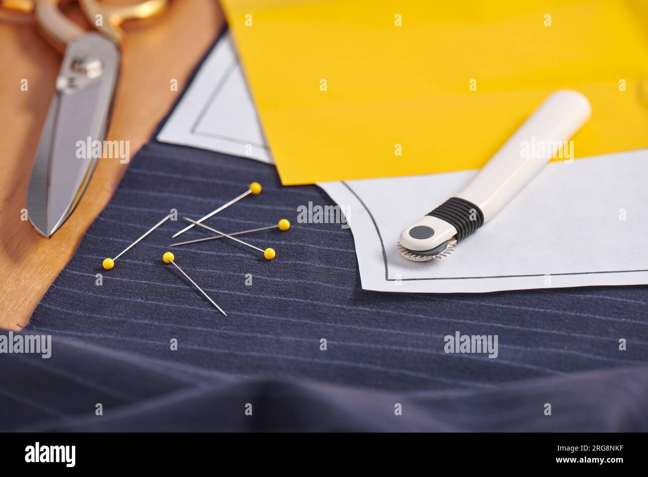 Sewing pattern on fabric, tracing wheel, tracing paper, sewing equipment  Stock Photo - Alamy