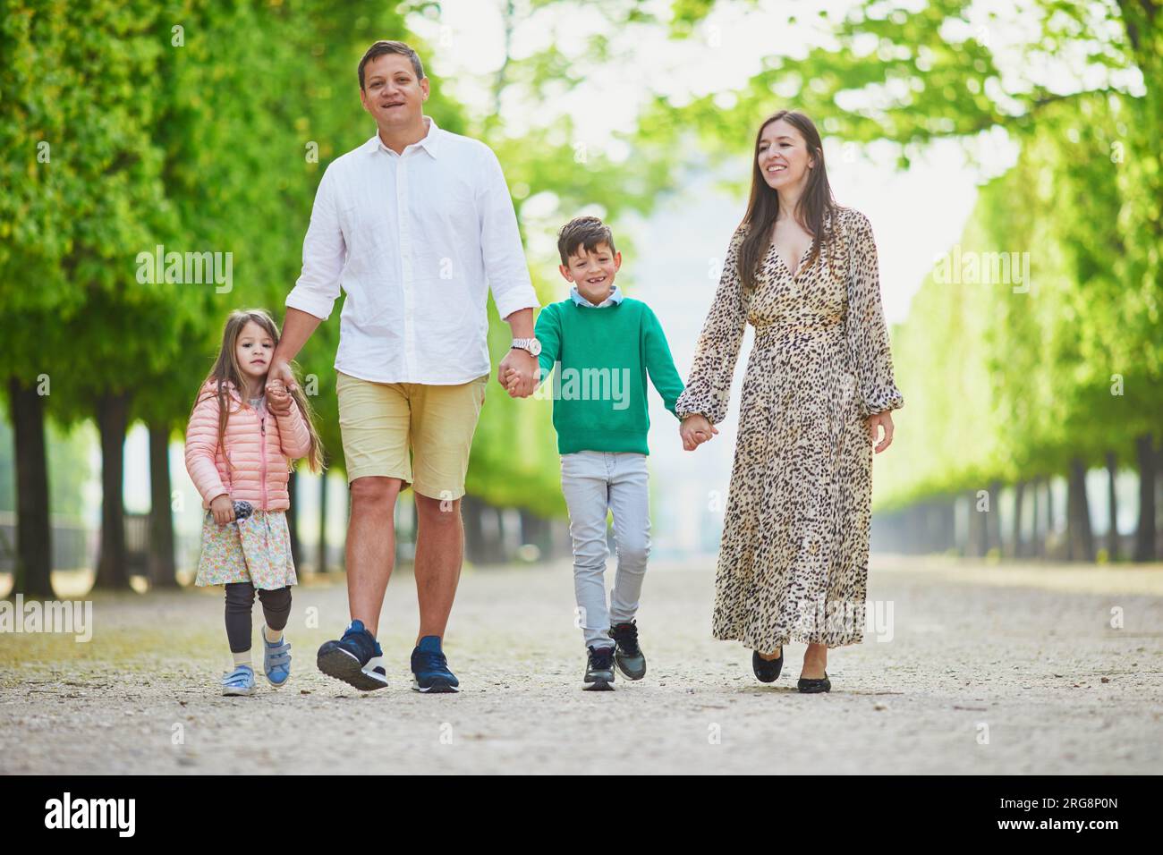Happy family of four enjoying their trip to Paris, France. Mother ...