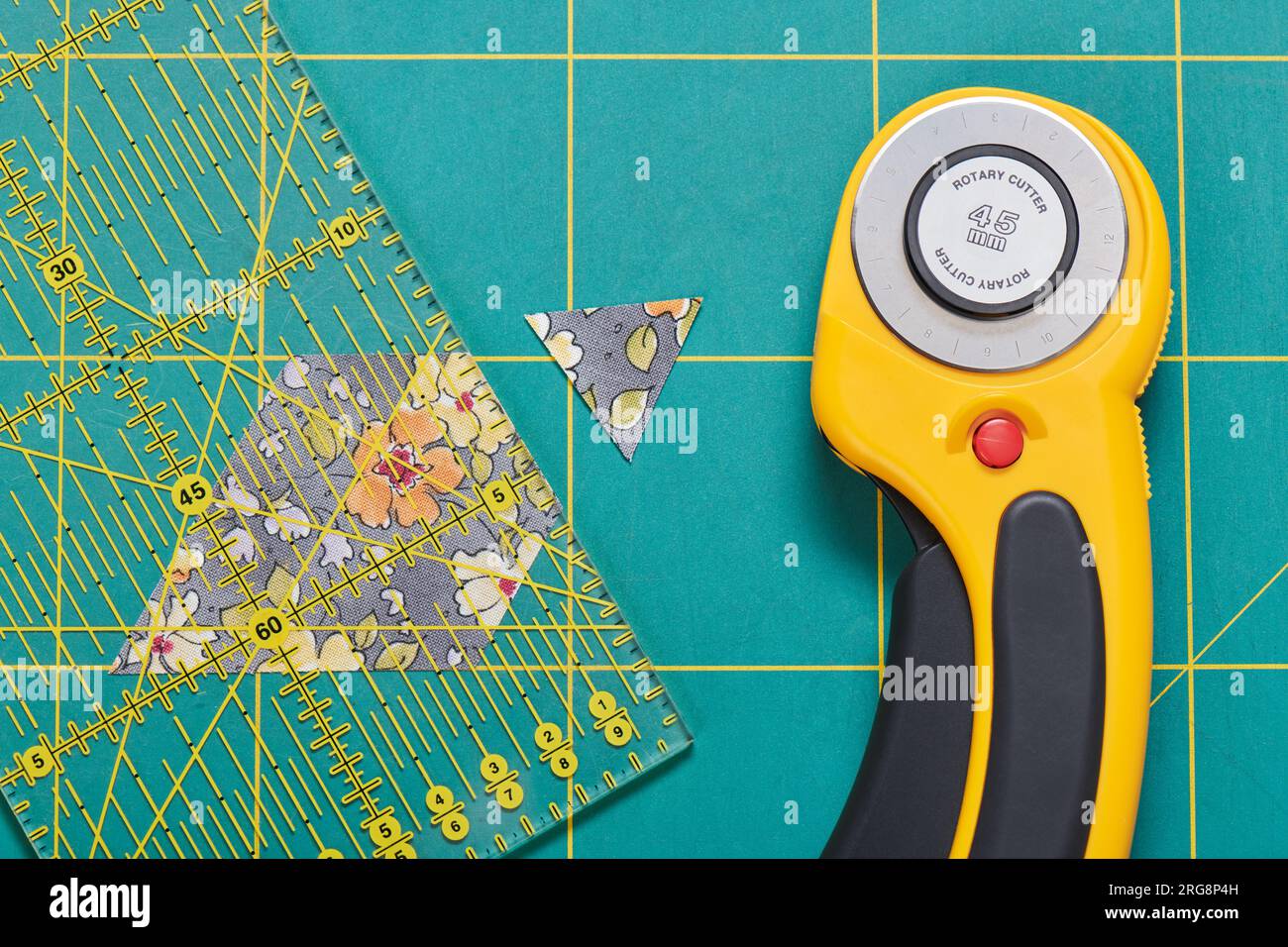 The process of cutting pieces of fabric in the shape of hexagons to create a quilt Stock Photo