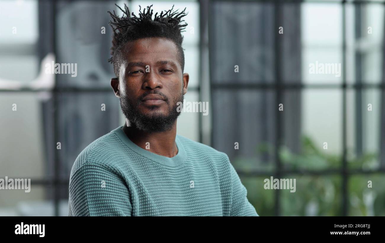 Thoughtful young black man looking straight ahead Stock Photo