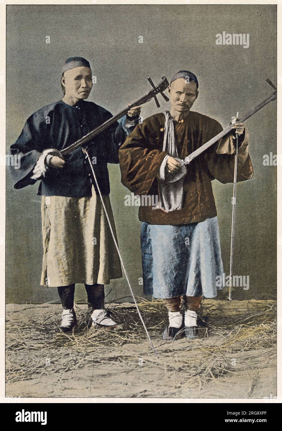Two blind beggars playing stringed instruments. Stock Photo