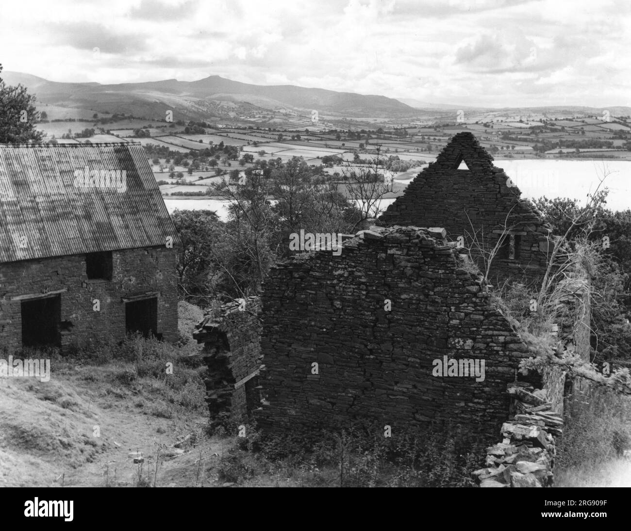 A derelict old Welsh farmhouse with panoramic views of Llangorse Lake and Brecon Beacons, Breconshire, Wales. Stock Photo