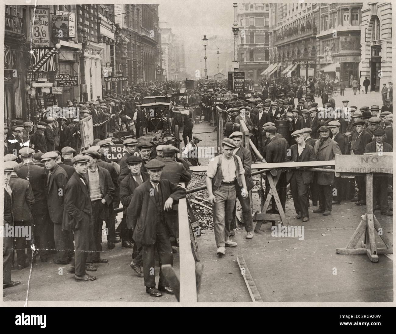 Disruption in Piccadilly, London, with crowds of people watching work being done on part of the main road. Stock Photo