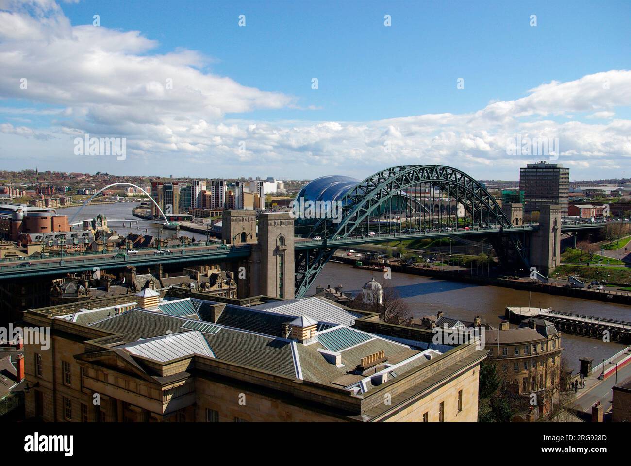 The Tyne Bridge is a compression arch suspended-deck bridge linking Newcastle upon Tyne and Gateshead. It was designed by the engineering firm Mott, Hay and Anderson, who later designed the Forth Road Bridge, and was built by Dorman Long and Co. of Middlesbrough. It was officially opened on 10 October 1928 by King George V. Stock Photo