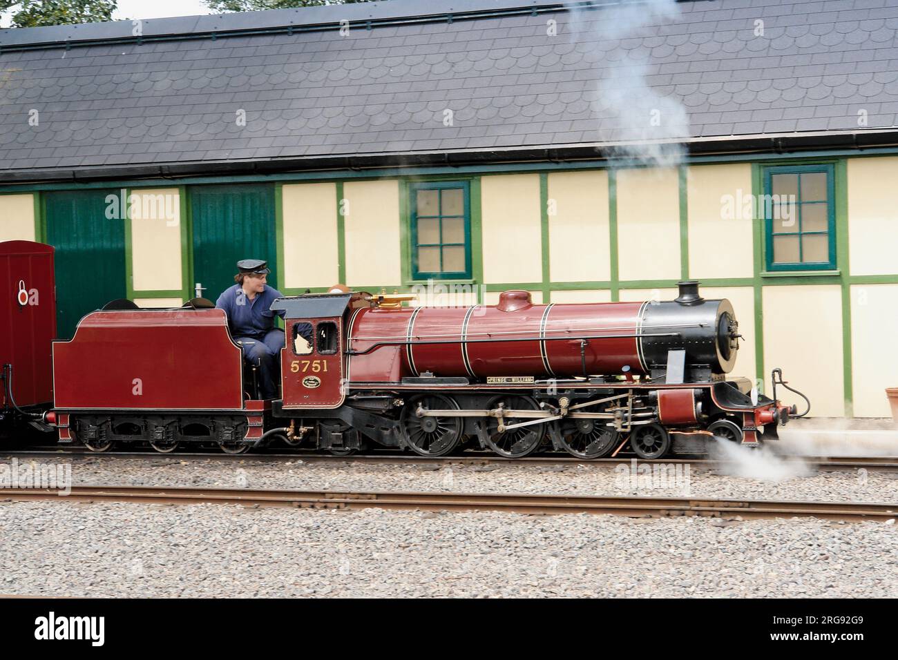 View of the engine and driver of the Evesham Vale Light Railway, one of the family attractions at Evesham Country Park, Worcestershire.  This miniature steam passenger railway opened in August 2002 with a narrow 15' gauge. Stock Photo