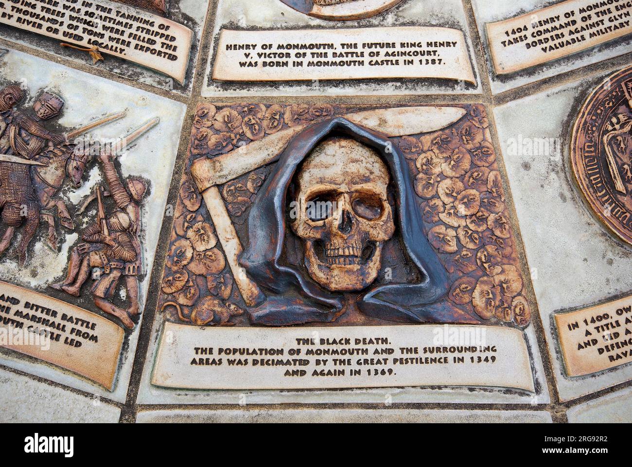 A Death's Head design on the Table Top Plaque, which depicts the history of Monmouth, Gwent, in several scenes.  This particular design commemorates the Black Death, which decimated the population of Monmouth and the surrounding area in 1349 and 1369. Stock Photo