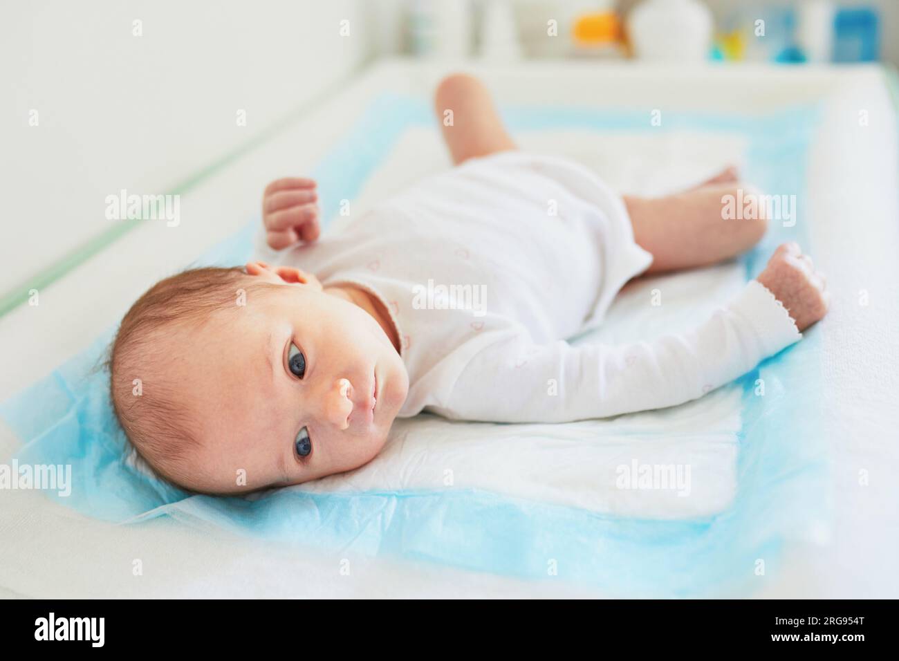 Newborn baby girl lying on changing table Stock Photo Alamy