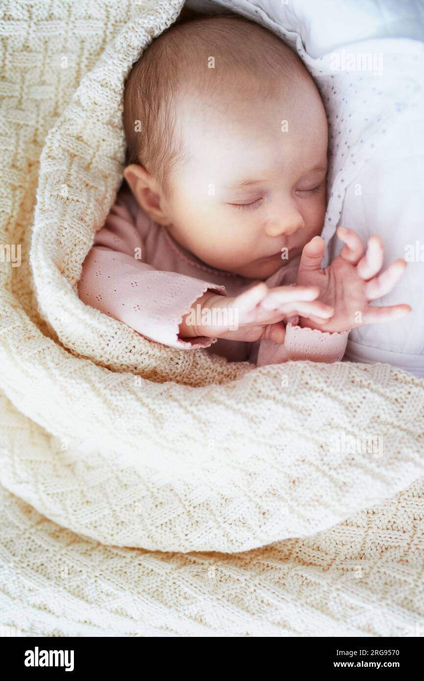 Adorable baby girl sleeping in the crib. Little child having a day nap