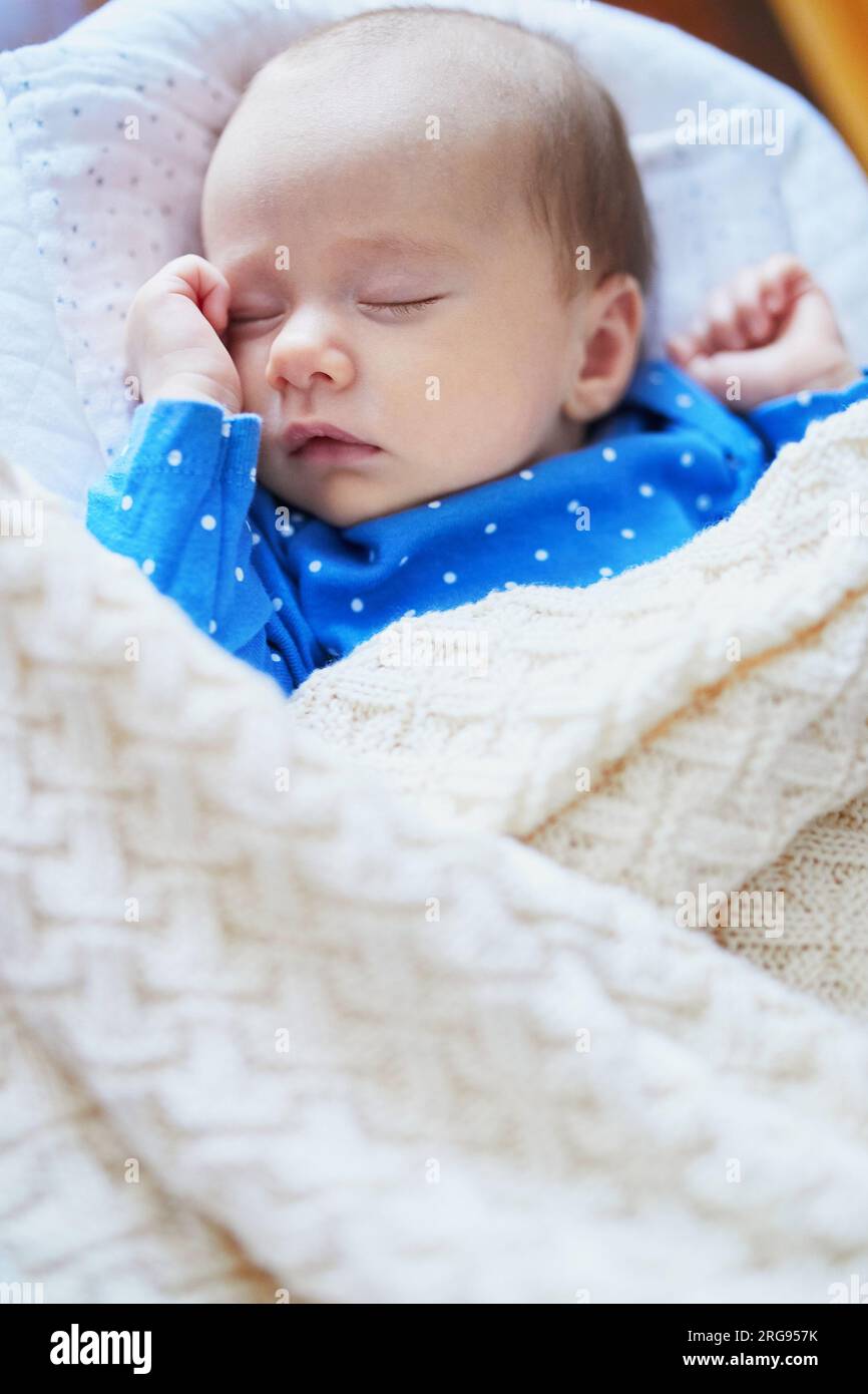 Adorable baby girl sleeping in the crib. Little child having a day nap