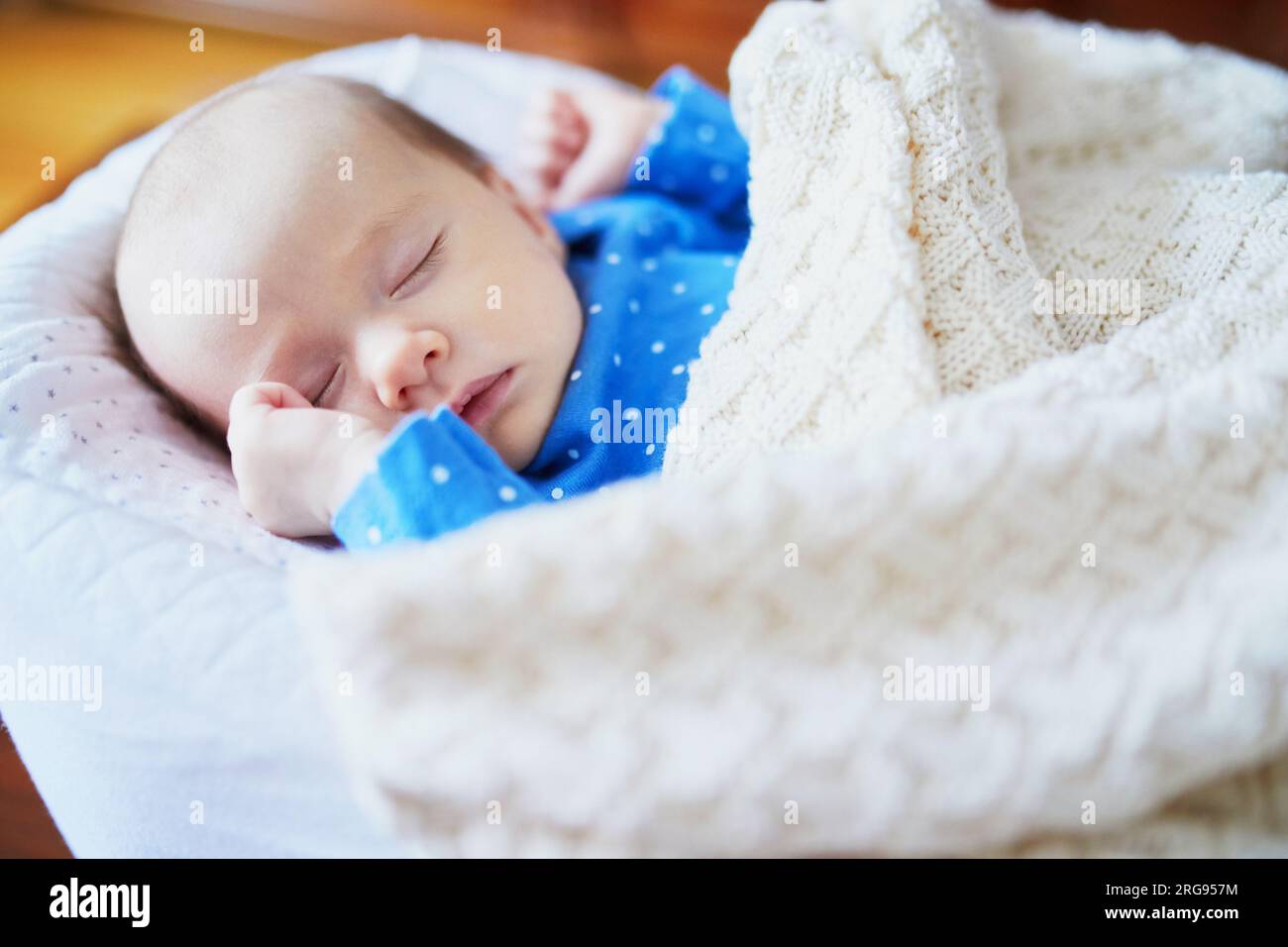 Adorable baby girl sleeping in the crib. Little child having a day nap
