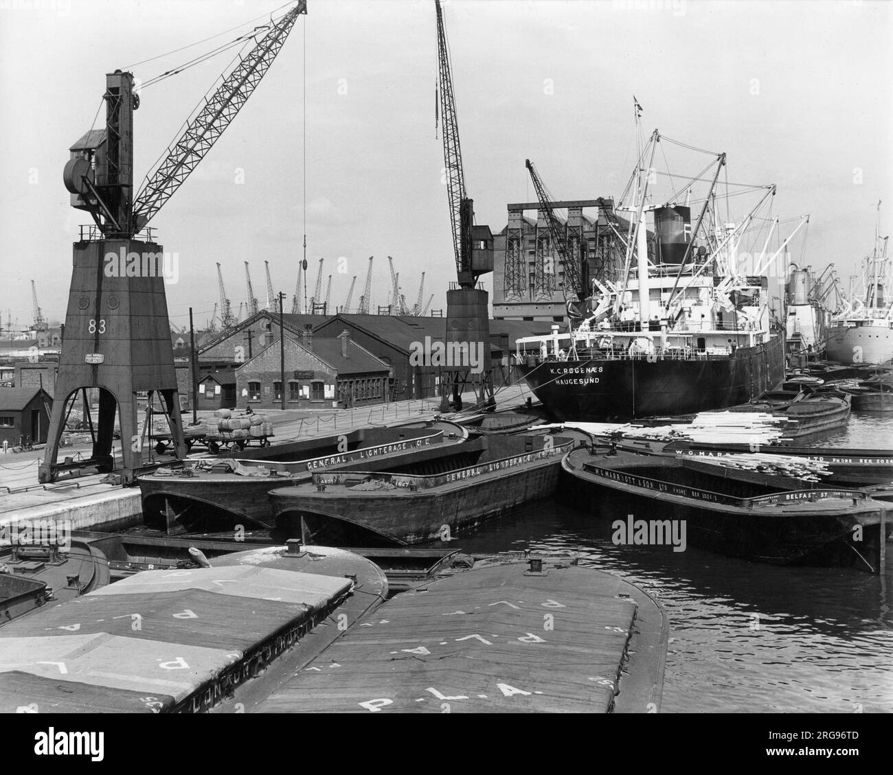 Dockside scene with vessels and cranes on the River Thames, Port of London. Stock Photo