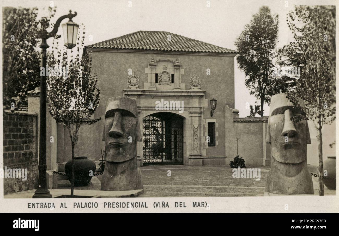 Entrance of the Presidencial Palace (Vina del Mar), Chile - two reproduction Easter Island Heads (Moai) stand guard before the gateway. The Palace of Cerro Castillo (Palacio de Cerro Castillo) is the official country retreat and summer residence of the President of Chile. Constructed in 1929 in the Spanish Colonial Revival style. Stock Photo