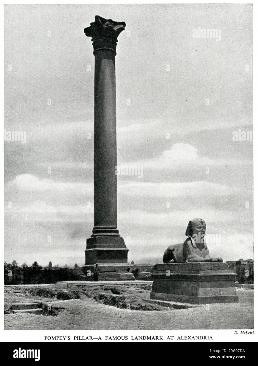 Pompey's Pillar and Sphinx, Alexandria, Egypt. The pillar is a Roman triumphal column, erected in 297 AD to commemorate the victory of the Emperor Diocletian over an Alexandrian revolt. Stock Photo