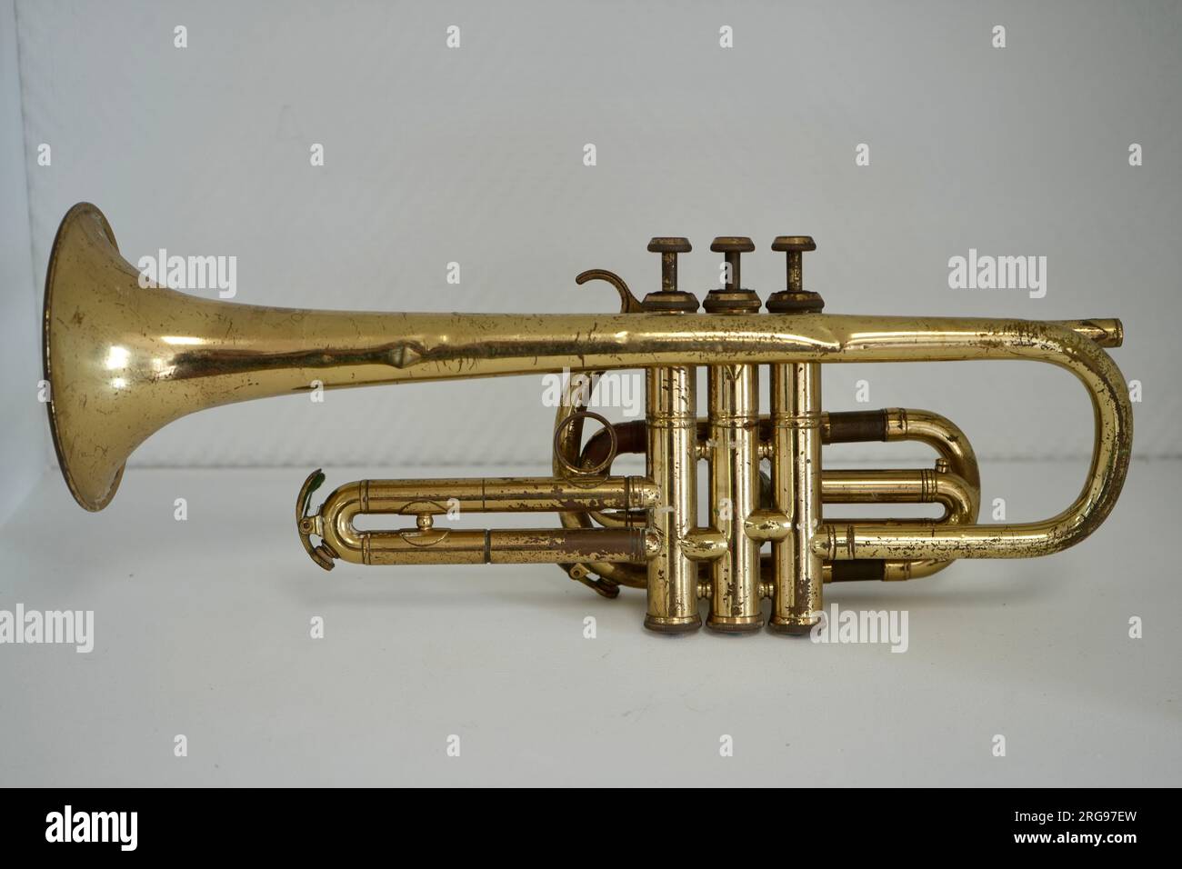 Gold Coloured Vintage Antique French Trumpet with white background