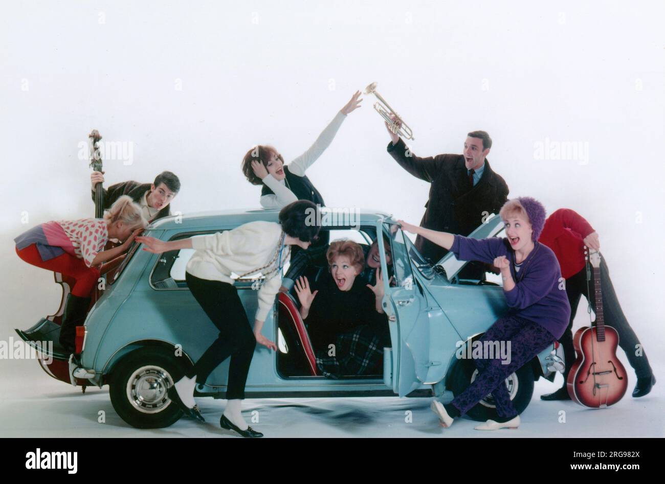 Advertisement for CPV (Colman Prentis & Varley) - group of Beatniks (some holding musical instruments!) trying to squeeze into an Austin A7. Stock Photo