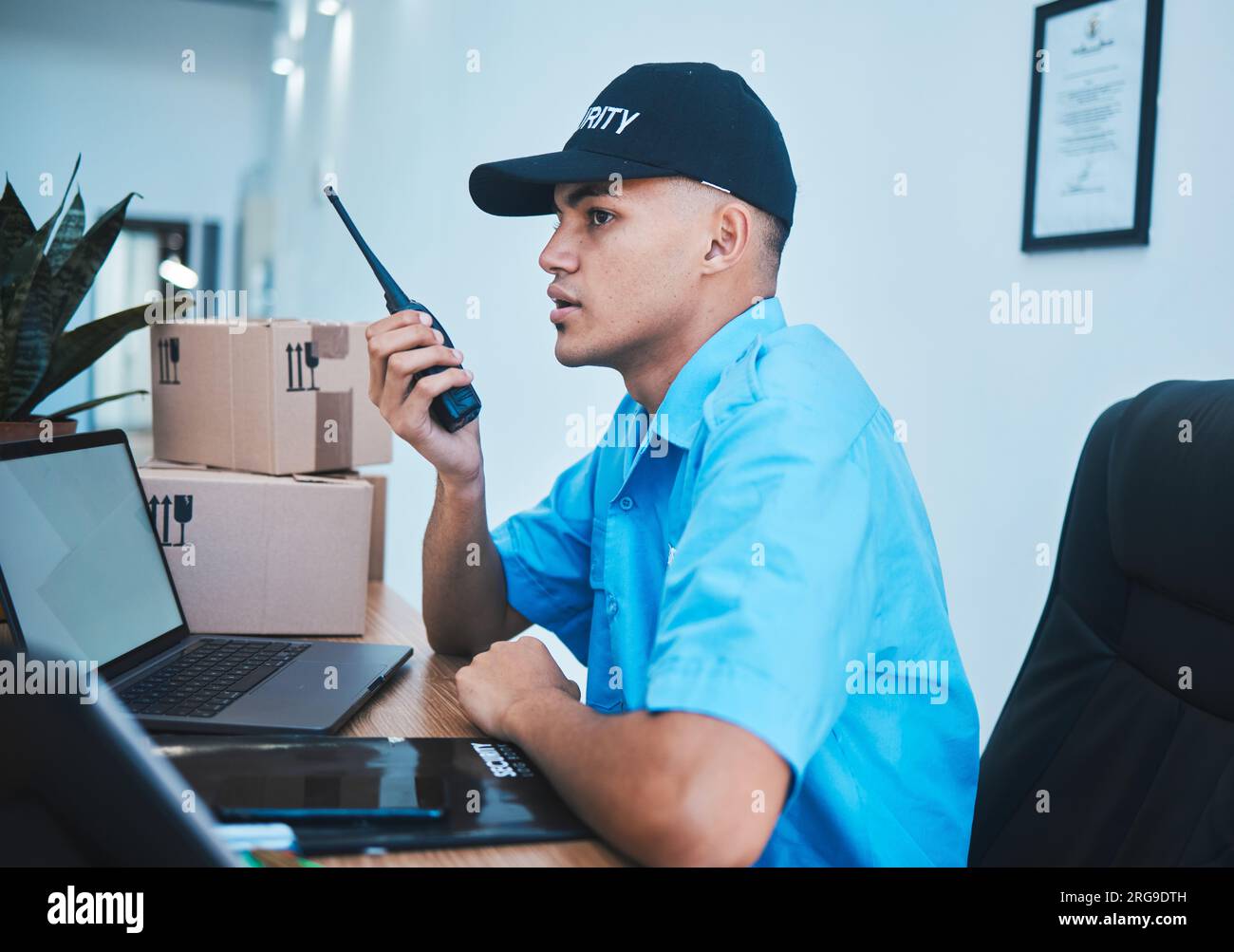Walkie talkie, security guard and man at table in surveillance,  communication in an office. Safety, protection and serious officer on radio at  desk to Stock Photo - Alamy