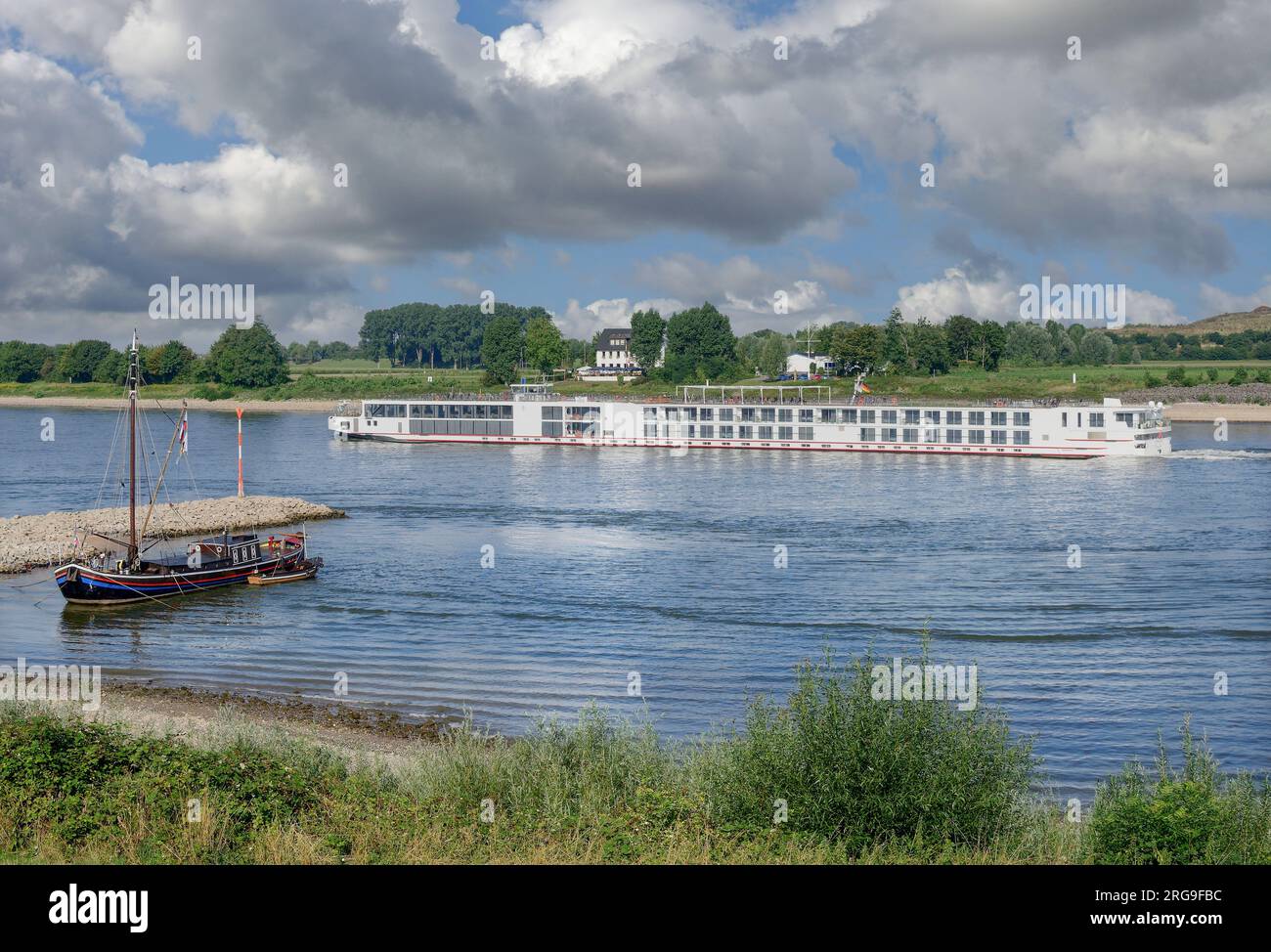 Traditional Eel Fishing Boat Called Aalschokker And River Cruise Ship 