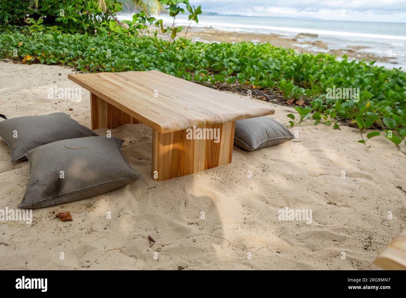 beach table, set over white sand Stock Photo Alamy