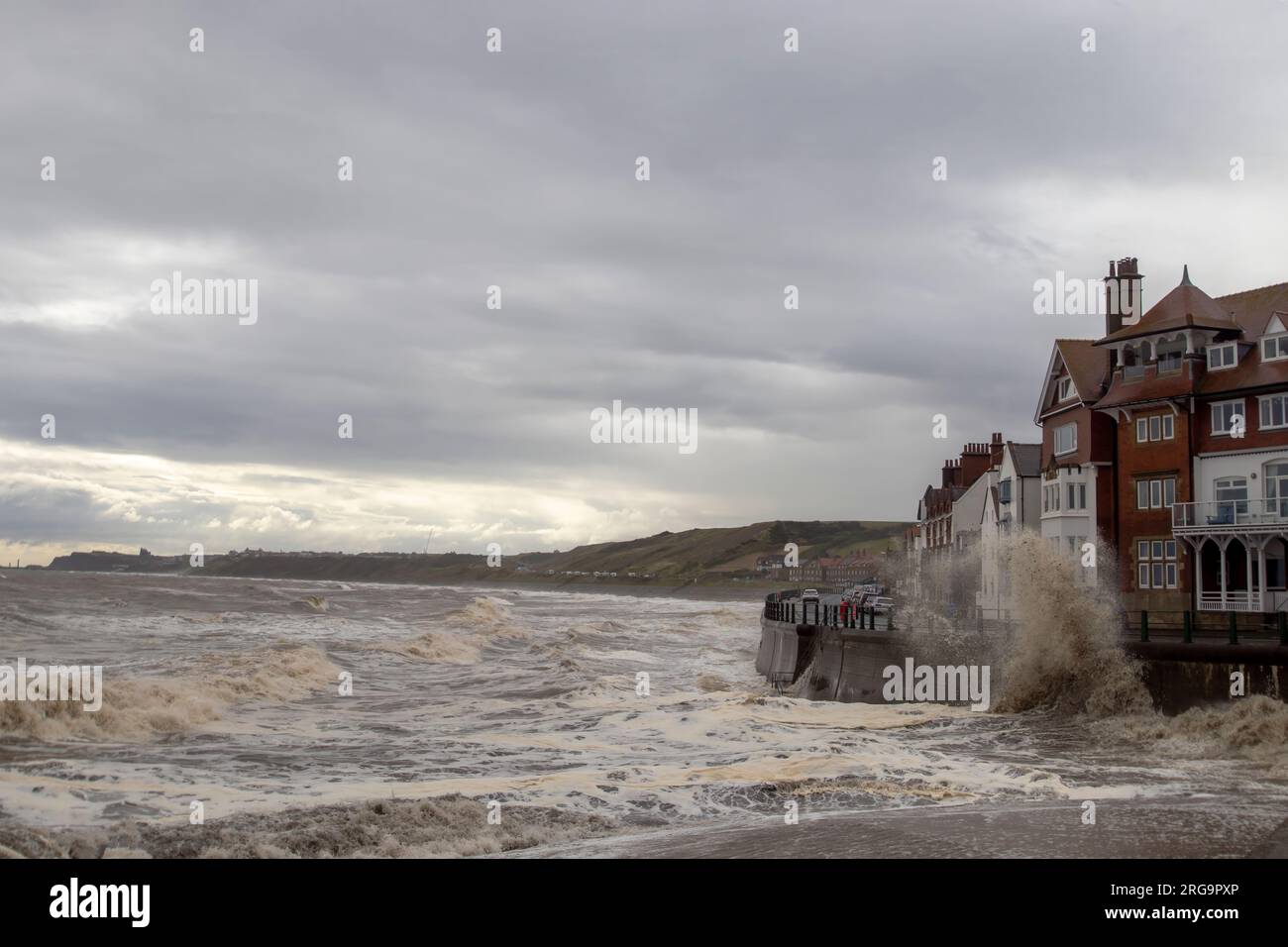 Waves crashing into the sea defences in Sandsend, North Yorkshire, UK Stock Photo