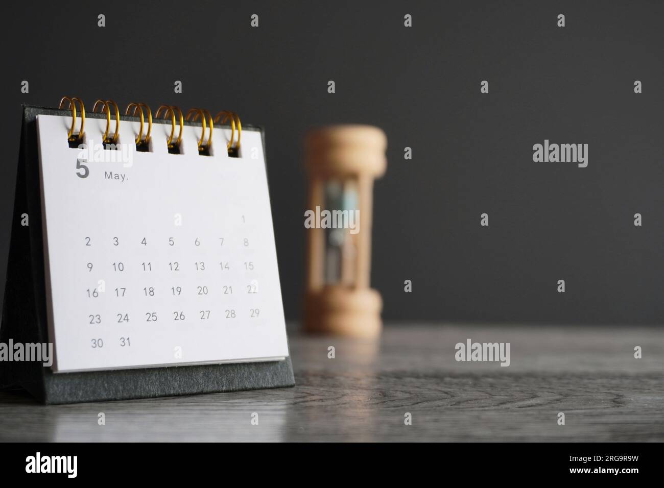 Close up image of calendar and hourglass with copy space. Deadline, time limit and period concept. Stock Photo